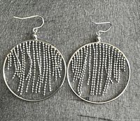 Front view of both earrings showing hoop shape and fringe