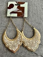 Front view of earrings on original twentyone card showing enamel detailing