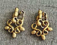 Front view of both gold-tone clip-on earrings showing design