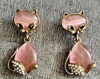 Front view showing both earrings, cat motif, stones
