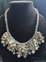 Full front view of iridescent glass and stone chip bib necklace on bust