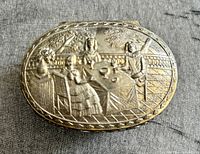 Top view showing embossed scene and oval form