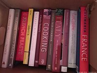 Box row showing 13 French and Italian cookbooks spines