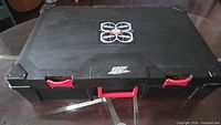 Closed black carrying case showing exterior and latches