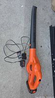Full view of leaf blower with charger cords