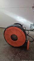 Left side view showing orange intake cover and outlet