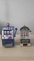 Front view of both mini slot machine coin banks