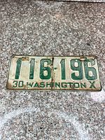 Full view of license plate showing number, lettering, color and condition