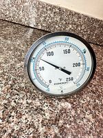 Front view of Ashcroft dial thermometer showing full scale