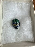 Front of azurite-malachite cabochon showing polished surface and colour pattern