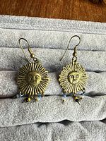 Both earrings front view on fabric roll
