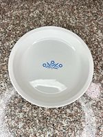 Top view of white CorningWare pie plate displaying blue floral design