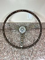 Full view of three-spoke steering wheel showing overall condition