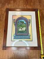 Front view of framed print with measuring tape showing size