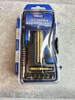 Front view of sealed Gunmaster pistol cleaning kit in clamshell packaging
