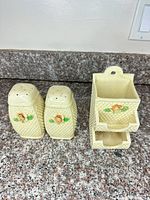 Front view of both shakers and wall pocket