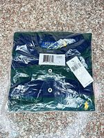 Folded green and navy striped Polo Ralph Lauren shirt in clear packaging with tags visible