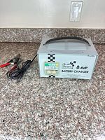Front view of Sears 8A battery charger with clamps visible