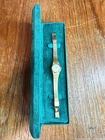 Watch in open green presentation box showing overall appearance