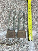 Two Slaymaker Super padlocks next to tape measure showing approx. 8" shackles