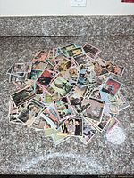 Pile of assorted 1967 The Monkees trading cards on countertop