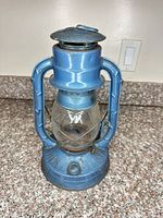 Full view of blue Dietz kerosene lantern showing overall design and color