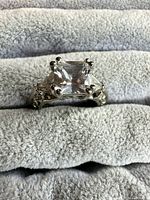 Top view showing princess-cut center stone and side stones