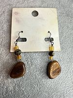 Front view of both earrings on card showing materials and overall design