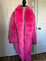 Front view of pink faux fur coat on mannequin