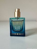 Front of perfume bottle showing brand, line name and design