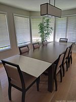 Table fully extended with both leaves inserted, eight chairs arranged