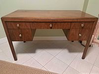 Front view showing full desk, drawers, legs