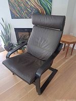 Front angled view showing overall chair design, leather cushions, bentwood frame