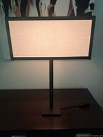 Lamp front view illuminated on sideboard