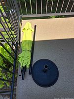 Umbrella folded, two pole sections, base overview