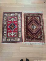 Two small accent rugs side by side showing patterns and fringe