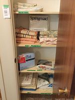 Closet shelves with assorted folded and packaged sheet sets