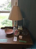 All items grouped: lamp, vase, shell bowl, porcelain floral pieces, candle