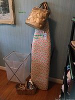 Entire lot showing ironing board, hamper, basket with iron and clothespins