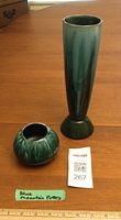Tall trumpet vase and small bulbous bowl on table with lot tag