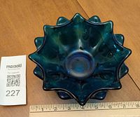 Top view of blue pressed glass bowl showing ruffled edge and interior