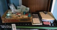 Shelf view showing box of medical supplies, Borg scale, Style House shower liner packaging