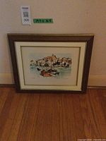 Full view of framed print on floor showing frame style and artwork