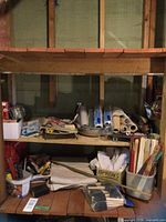 Shelf holding assorted painting supplies, overview