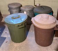 All five trash cans grouped together showing materials and colors