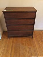 Front view of Mid-Century Modern dresser showing four drawers and tapered legs