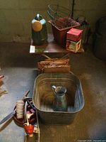 Full lot overview with table, watering can, wire basket, pots, feeder box, tub, pitcher, tools