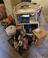 Lot overview showing wicker shelf, shaver box, foot spa, mirrors, wooden storage box
