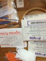 Mary Maxim leaflet, wooden-handled tools, yarn tufts