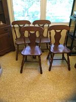 Front three-quarter view of all four chairs showing style and finish